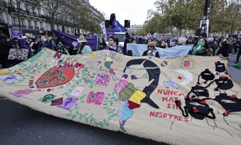 Demonstrators hold a banner with embroideries during a protest to condemn violence against women, called by feminist organisations two days prior to the international day for the elimination of violence against women, in Paris, on November 23, 2024. (Photo by STEPHANE DE SAKUTIN / AFP)